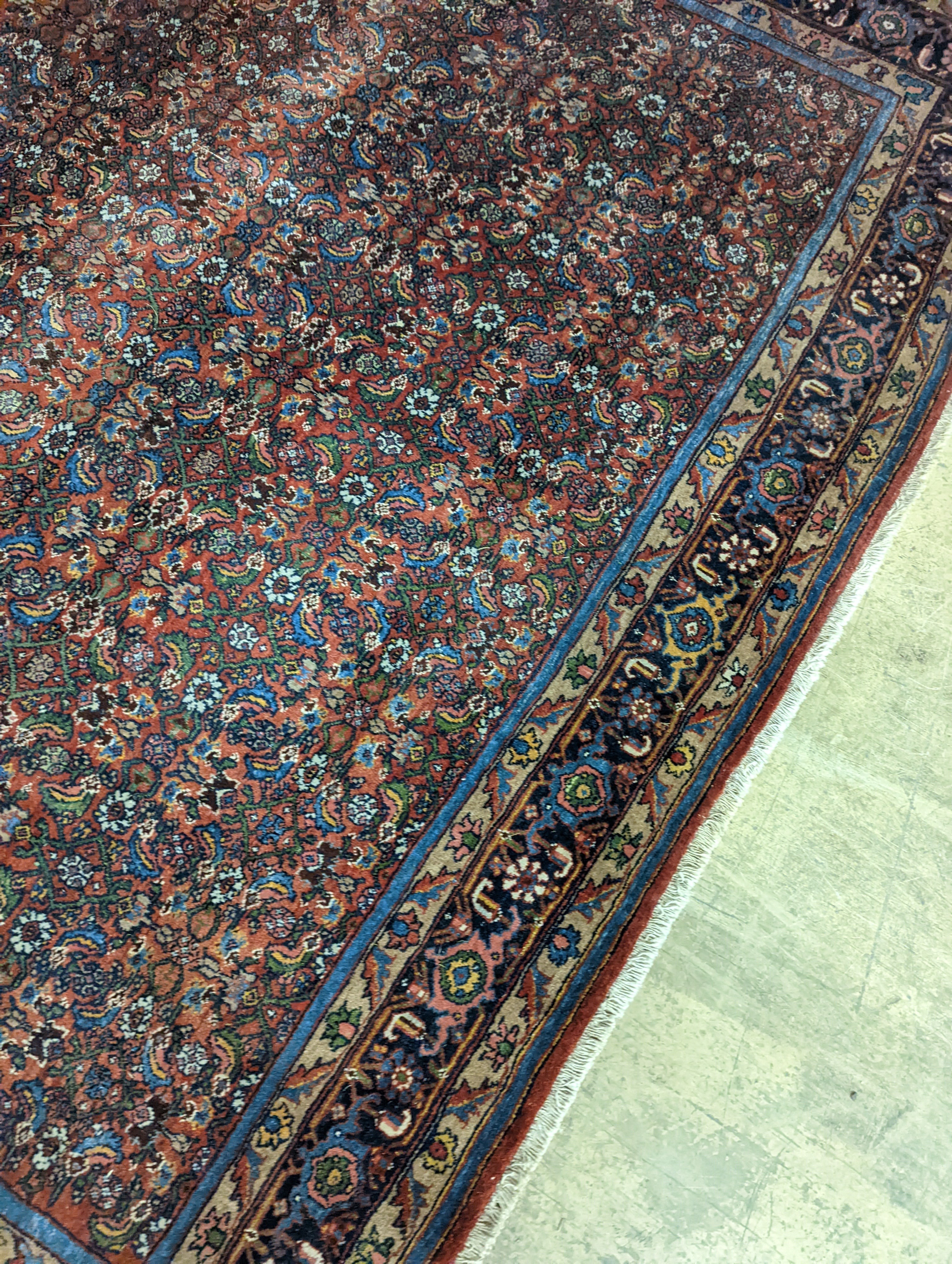 A North West Persian red ground carpet, 360 x 250cm